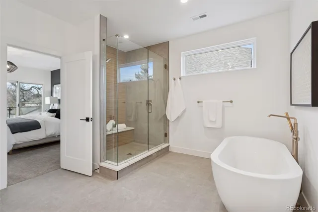 a spacious bathroom with a bathtub and shower