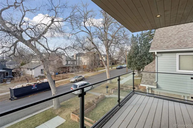 a view of a balcony with wooden floor and bench