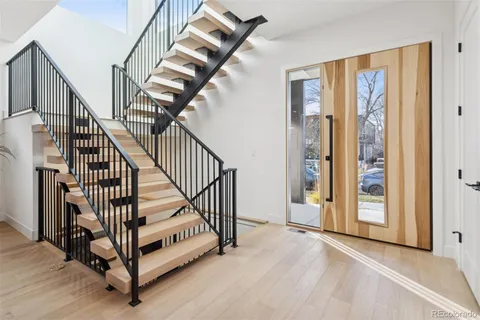 a kitchen with stainless steel appliances kitchen island granite countertop a table chairs and a refrigerator