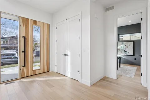 a view of living room with stainless steel appliances wooden floor and living room view