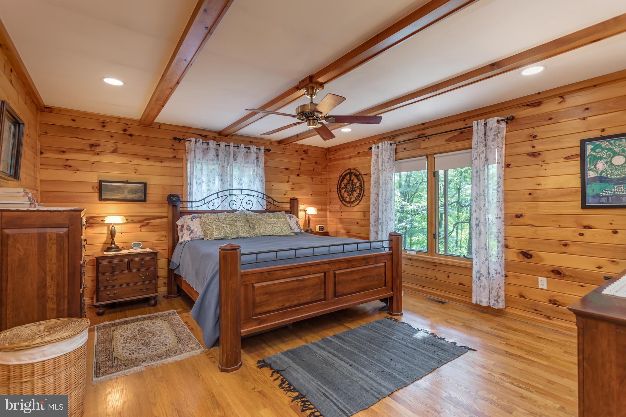 379 Wintergreen Way Berkeley Springs, WV 25411 - Photo 13 of 55 a bedroom with a bed and wooden floor