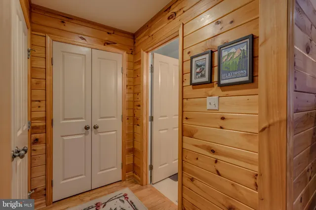 a view of a hallway with wooden floor and windows