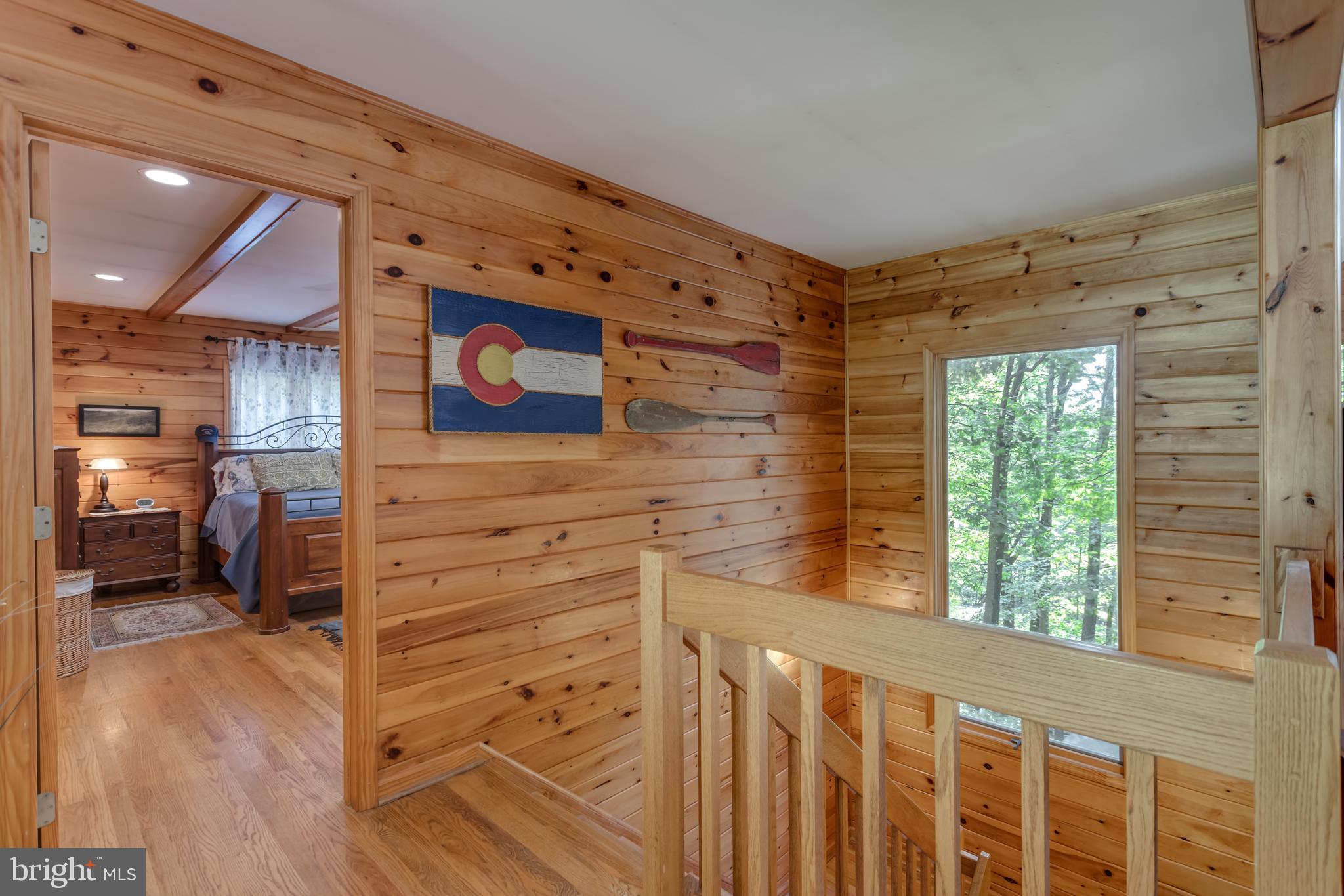 379 Wintergreen Way Berkeley Springs, WV 25411 - Photo 17 of 55 a view of a hallway with wooden floor and windows