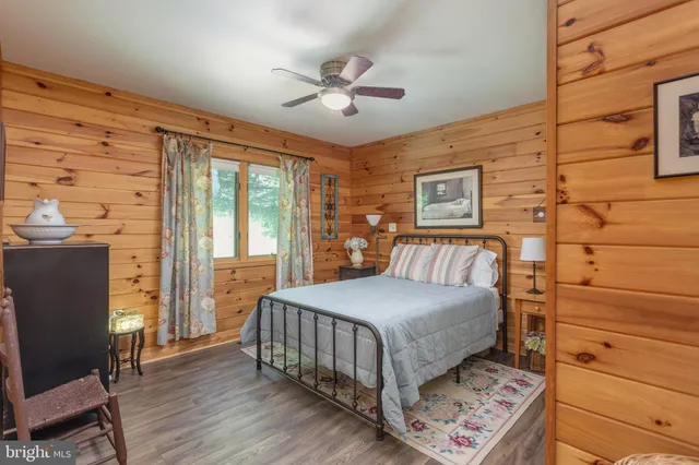a living room with furniture kitchen view and a large window