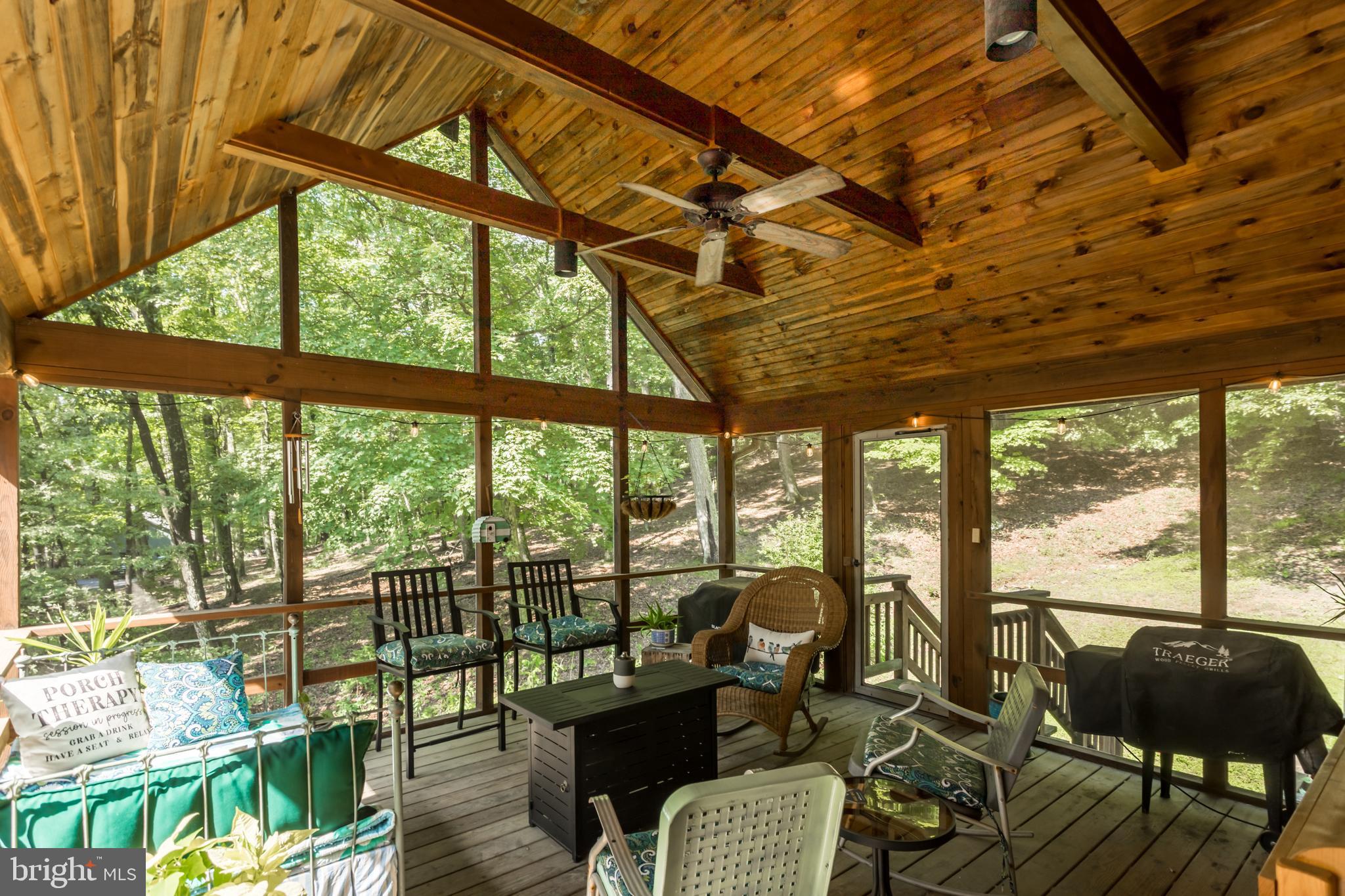 379 Wintergreen Way Berkeley Springs, WV 25411 - Photo 33 of 55 a living room with furniture and floor to ceiling windows