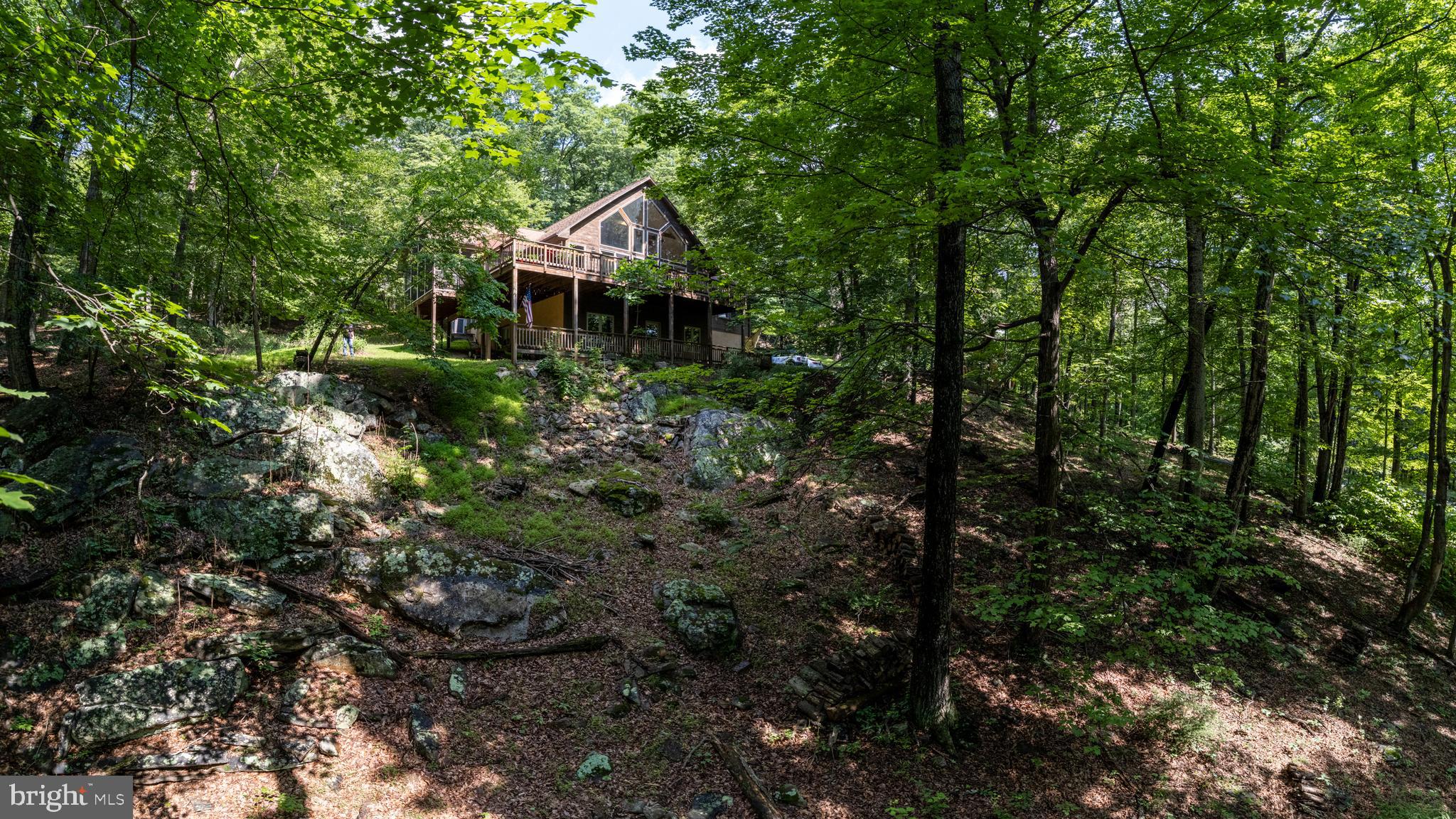 379 Wintergreen Way Berkeley Springs, WV 25411 - Photo 50 of 55 a yellow house with lots of trees