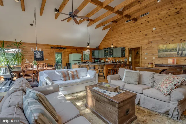a living room with furniture a large window and a flat screen tv
