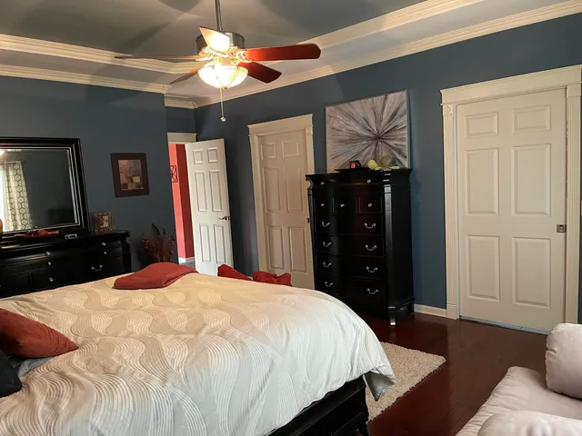 a bedroom with a bed and a dresser