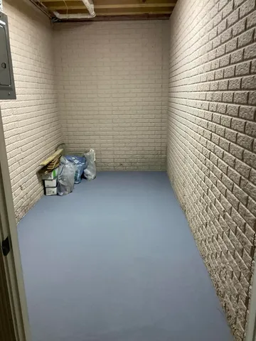 a view of a hallway with wooden floor and book shelf