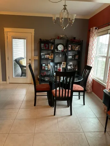 a dining room with furniture and window