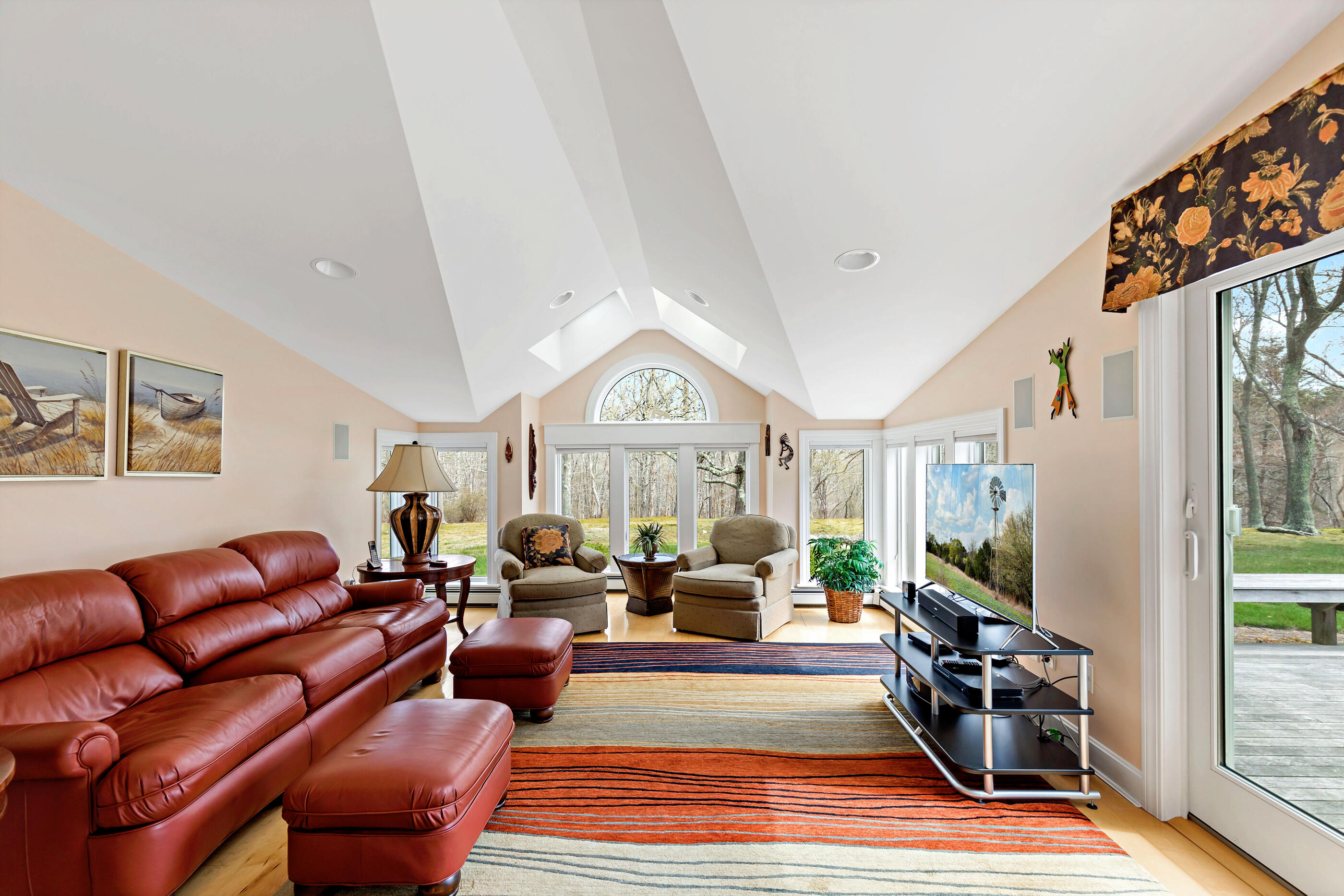 5 Shepherds Quay Brewster, MA 02631 - Photo 32 of 67 a living room with furniture a flat screen tv and a floor to ceiling window