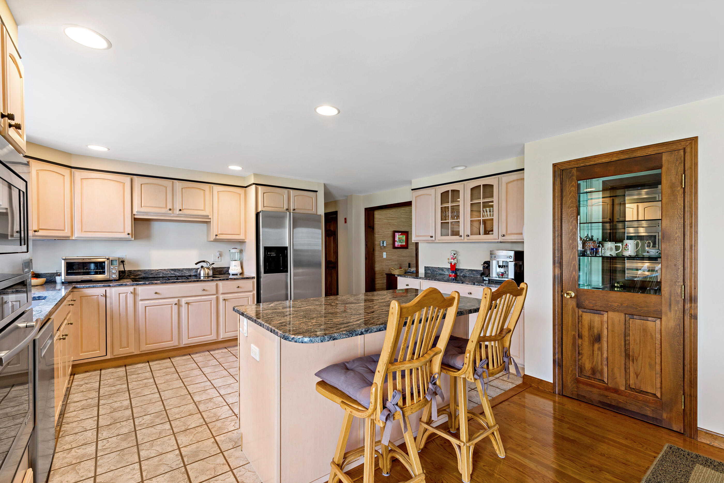 5 Shepherds Quay Brewster, MA 02631 - Photo 38 of 67 a kitchen with stainless steel appliances granite countertop a stove top oven a sink a dining table and chairs with wooden floor