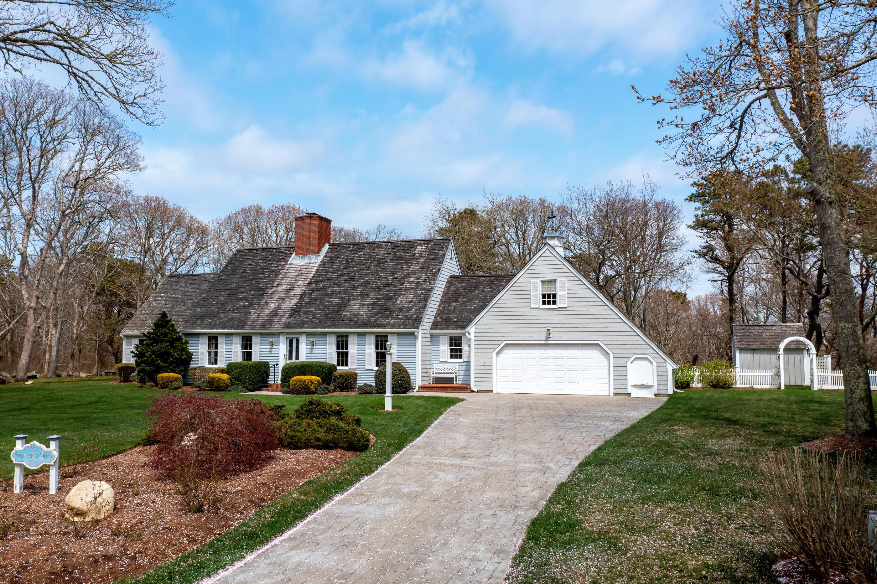 5 Shepherds Quay Brewster, MA 02631 - Photo 7 of 67 a front view of a house with a yard and garage