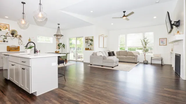 a kitchen with sink stove and wooden floor
