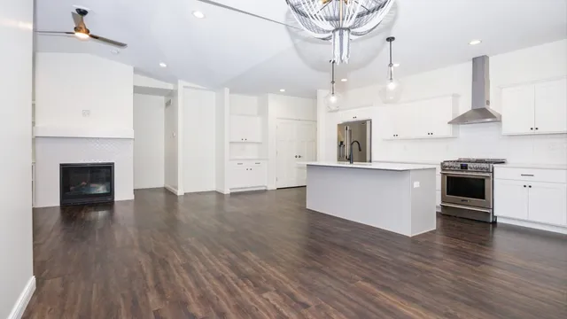 a view of an empty room with a fireplace and a window