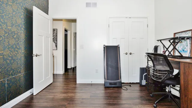a view of a workspace with furniture and a window