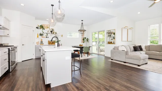 a living room with kitchen island furniture and a chandelier