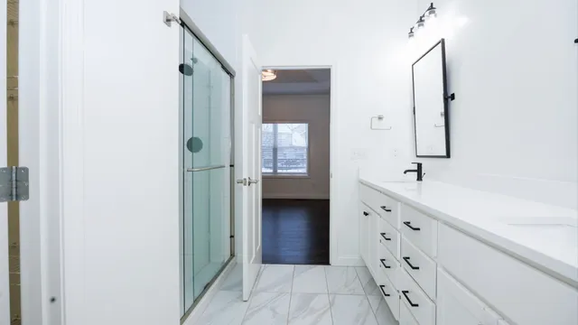 a bathroom with a double vanity sink a toilet and a mirror