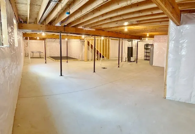 a kitchen with kitchen island stainless steel appliances sink and wooden floor