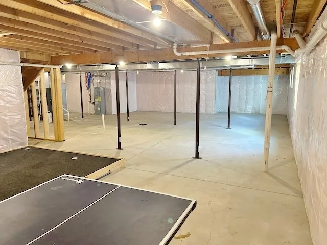 a view of open kitchen with white cabinets and stainless steel appliances