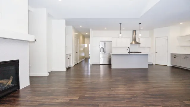 a view of a room with wooden floor and windows