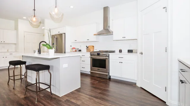 a kitchen with a stove cabinets and wooden floor