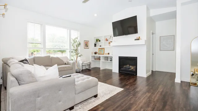 a kitchen with a table chairs stove and wooden floor
