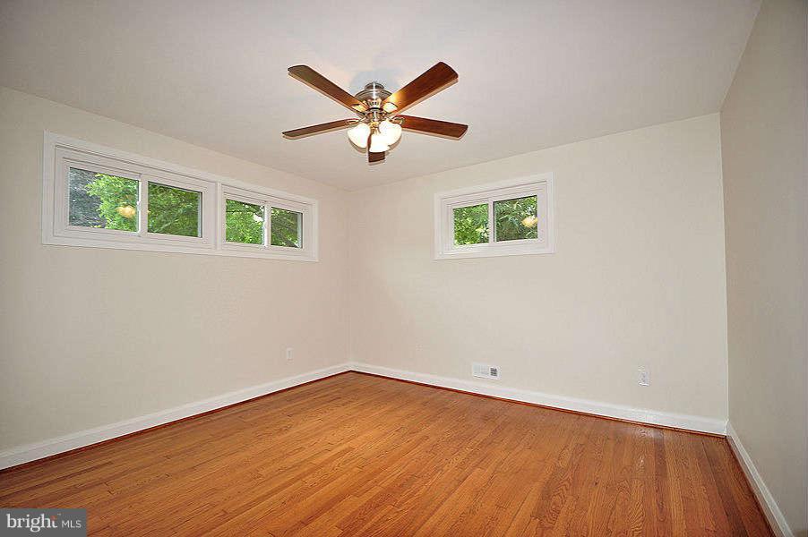 1319 Glendale Road Baltimore, MD 21239 - Photo 14 of 17 a view of a big room with wooden floor and windows