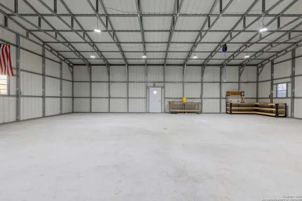 a view of a yard with basketball court