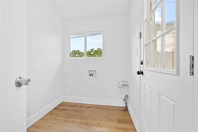a kitchen with granite countertop a sink cabinets stainless steel appliances and a window