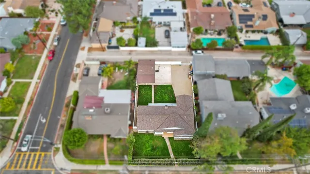 an aerial view of a house with a yard and plants