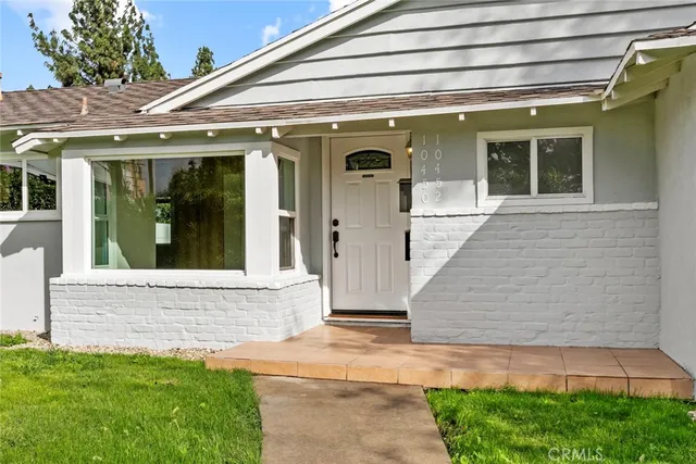 front view of the house with a yard