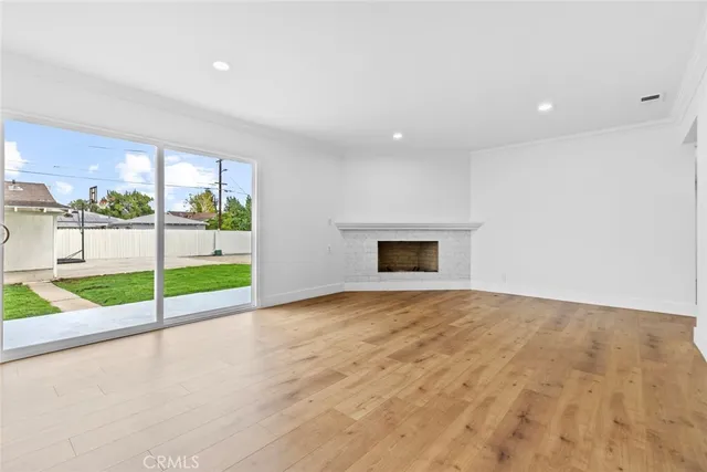 a view of a bathroom with wooden floor and a window