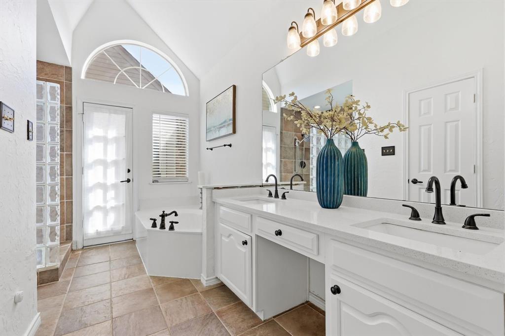 4350 Timberglen Road Dallas, TX 75287 - Photo 15 of 33 Bathroom with double vanity, a bath, vaulted ceiling, and walk in shower