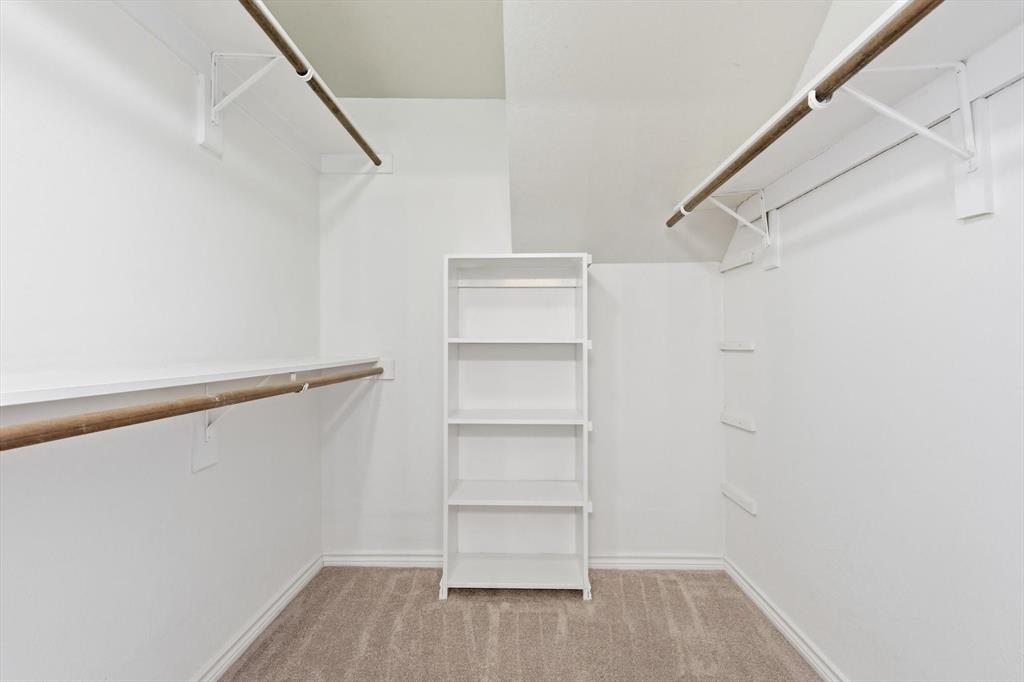 4350 Timberglen Road Dallas, TX 75287 - Photo 16 of 33 Walk in closet featuring light colored carpet