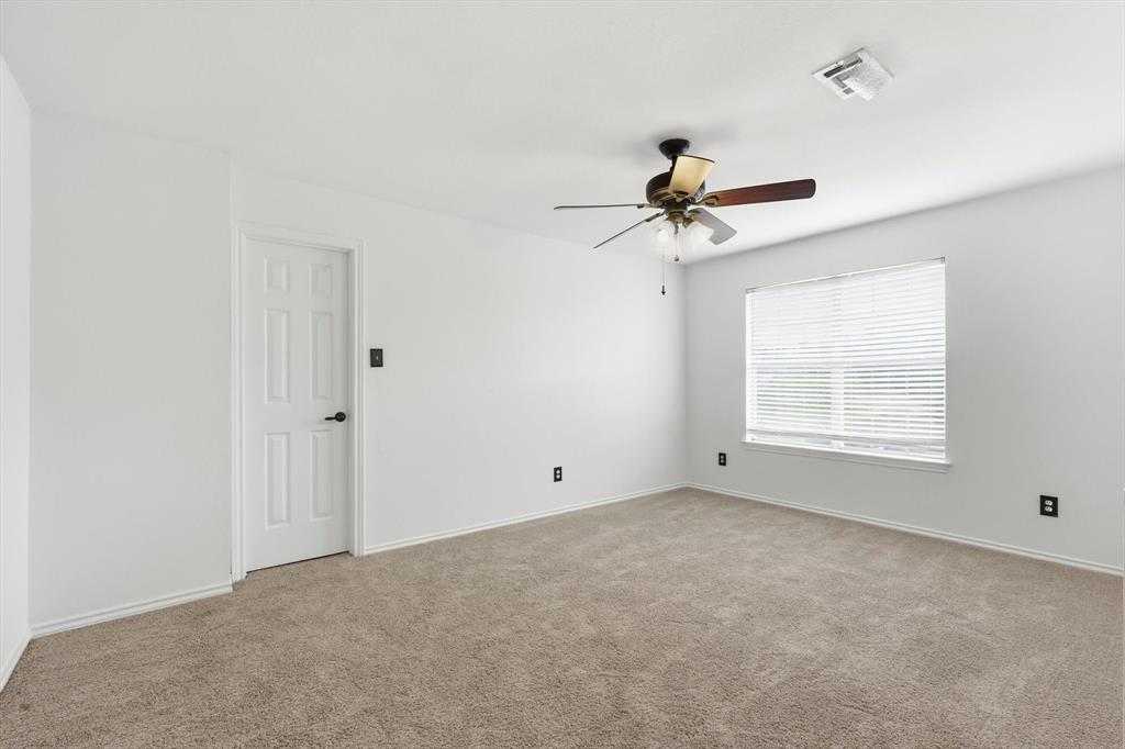 4350 Timberglen Road Dallas, TX 75287 - Photo 19 of 33 Carpeted spare room with baseboards and ceiling fan