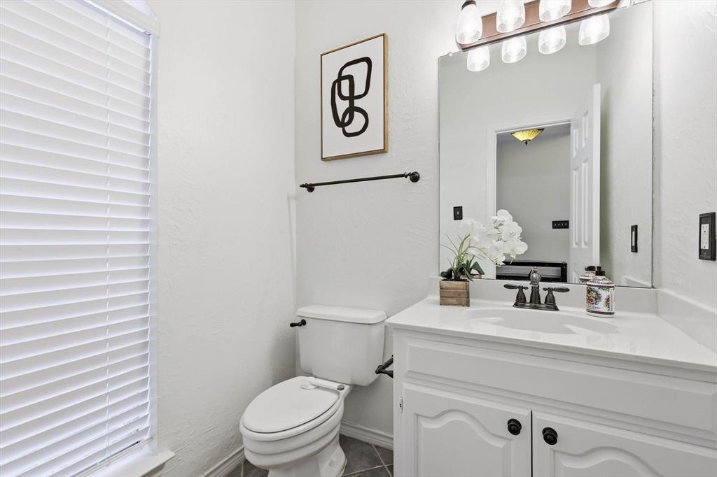 4350 Timberglen Road Dallas, TX 75287 - Photo 20 of 33 Bathroom with vanity and dark tile patterned floors