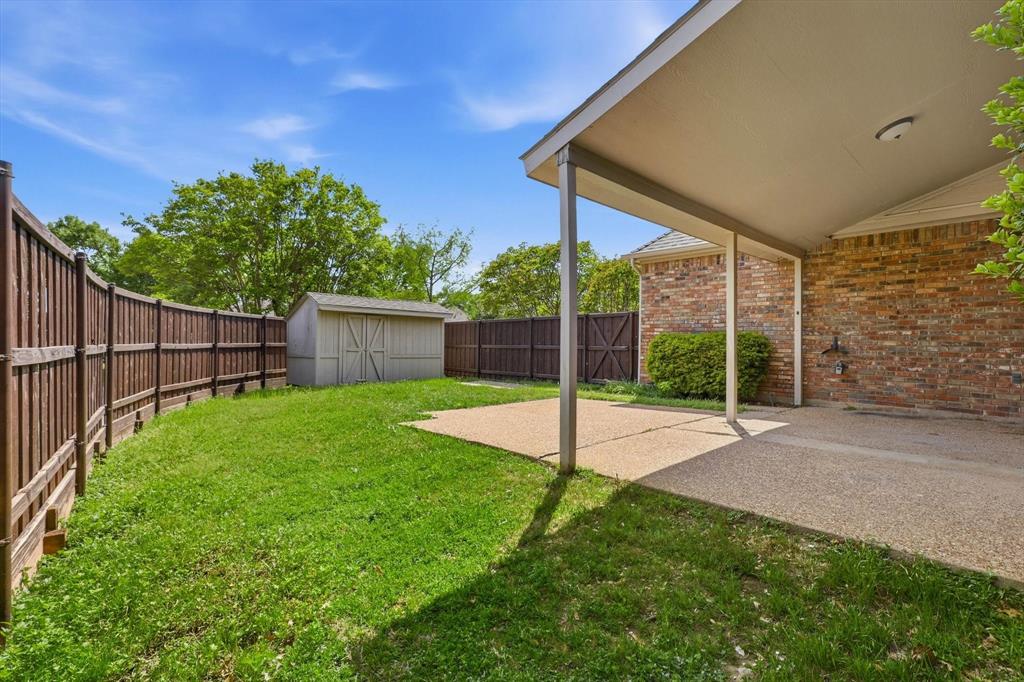 4350 Timberglen Road Dallas, TX 75287 - Photo 23 of 33 Fenced backyard with a patio and a shed