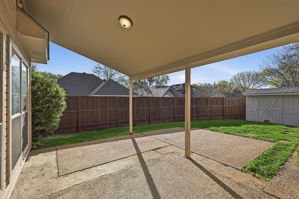 4350 Timberglen Road Dallas, TX 75287 - Photo 24 of 33 Fenced backyard featuring a patio area and a storage unit