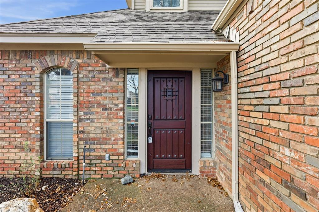 4350 Timberglen Road Dallas, TX 75287 - Photo 3 of 33 Property entrance featuring a shingled roof and brick siding
