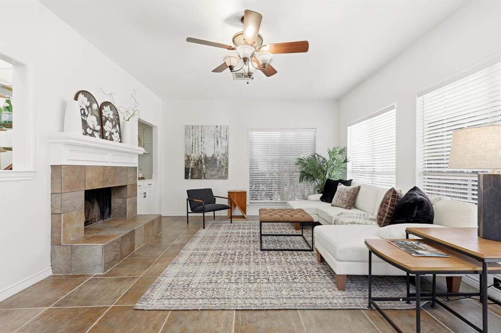 4350 Timberglen Road Dallas, TX 75287 - Photo 7 of 33 Living area featuring a ceiling fan and a tiled fireplace
