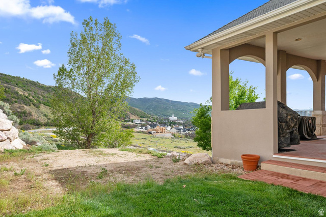 708 Eagle Rdg Drive Bountiful, UT 84010 - Photo 64 of 69 Covered patio with arched openings, overlooking distant structures and a mountainous landscape