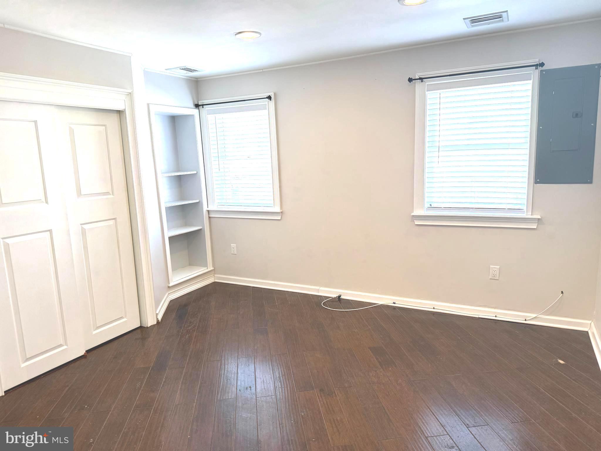 1512 West Shunk Street Philadelphia, PA 19145 - Photo 3 of 10 an empty room with wooden floor and windows