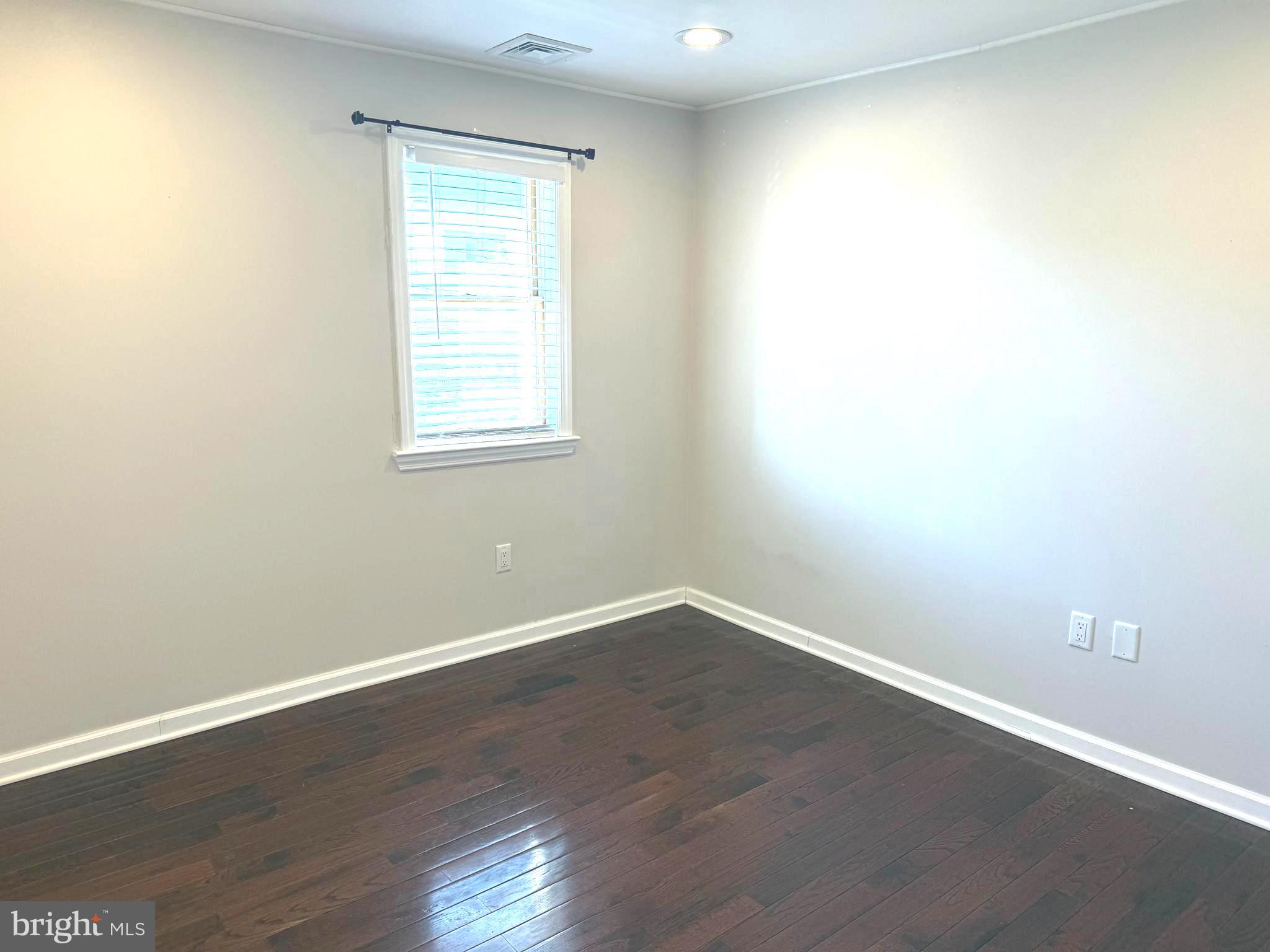 1512 West Shunk Street Philadelphia, PA 19145 - Photo 5 of 10 an empty room with wooden floor and windows