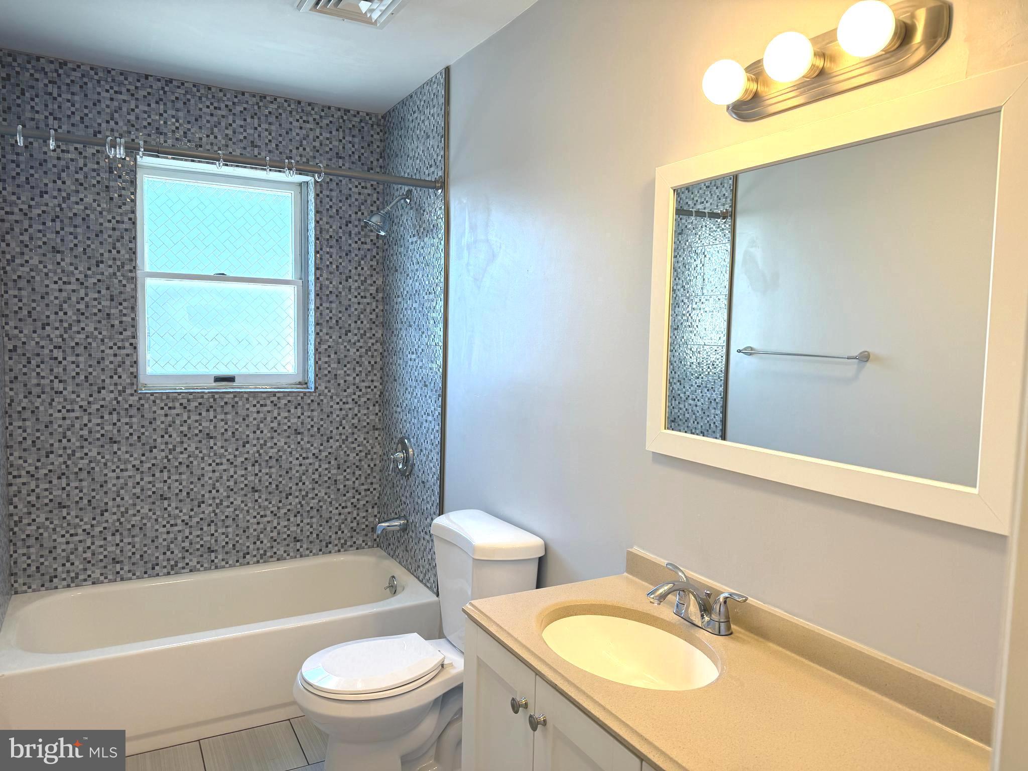 1512 West Shunk Street Philadelphia, PA 19145 - Photo 7 of 10 a bathroom with a sink toilet a bathtub and shower