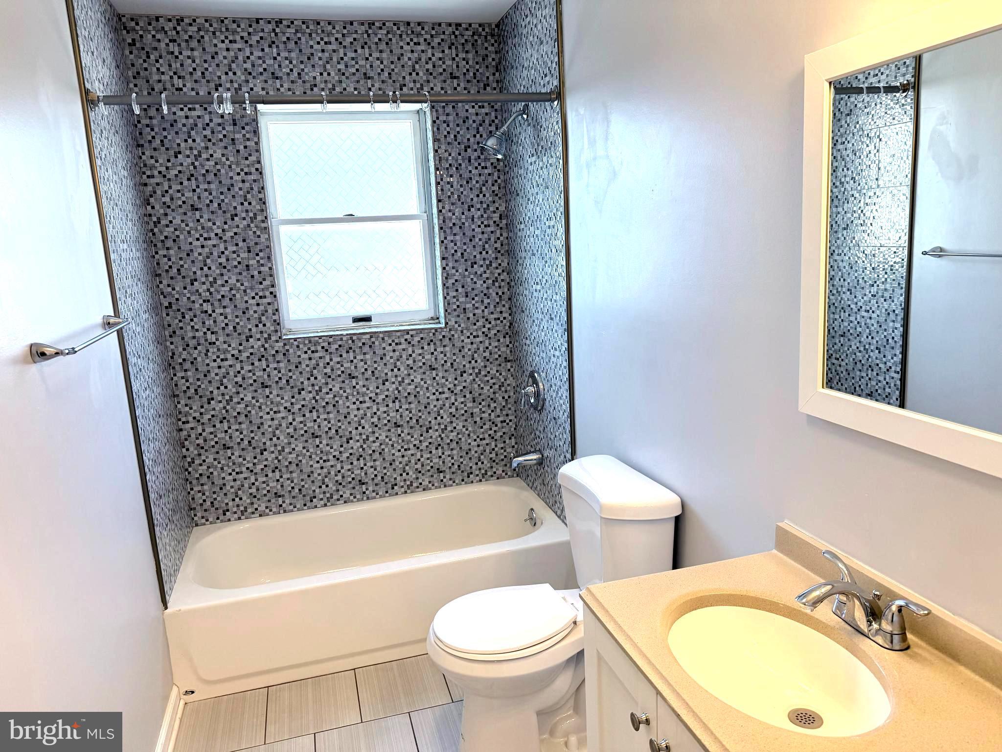 1512 West Shunk Street Philadelphia, PA 19145 - Photo 8 of 10 a bathroom with a toilet a sink and bathtub