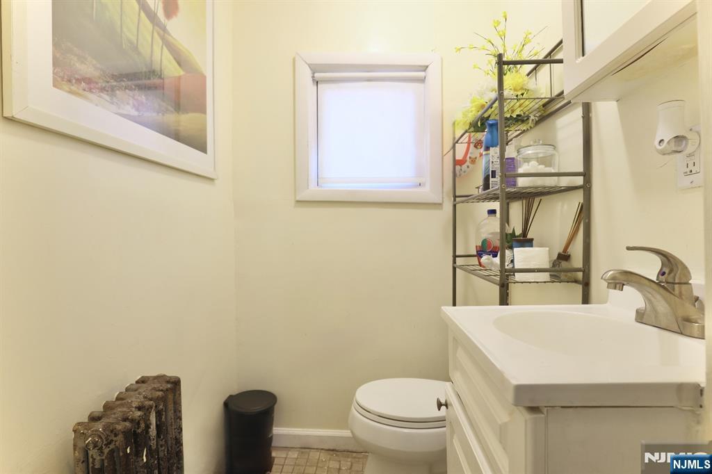 116 North 13th Street Newark, NJ 07107 - Photo 11 of 14 a bathroom with a sink a toilet and mirror