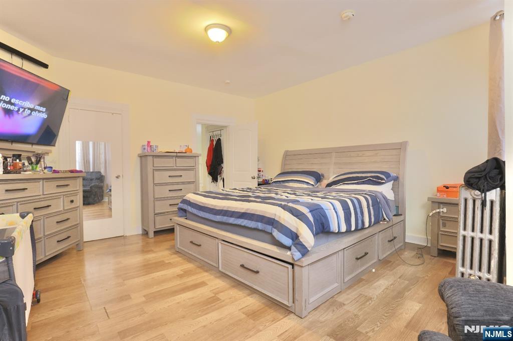 116 North 13th Street Newark, NJ 07107 - Photo 7 of 14 a spacious bedroom with a bed and a cabinets