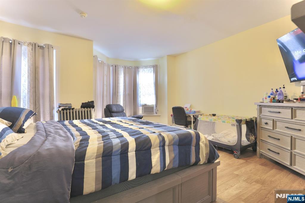 116 North 13th Street Newark, NJ 07107 - Photo 8 of 14 a bedroom with a bed and a dresser