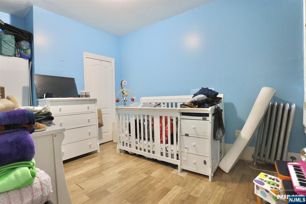 116 North 13th Street Newark, NJ 07107 - Photo 10 of 14 a bedroom with a bed and wooden floor